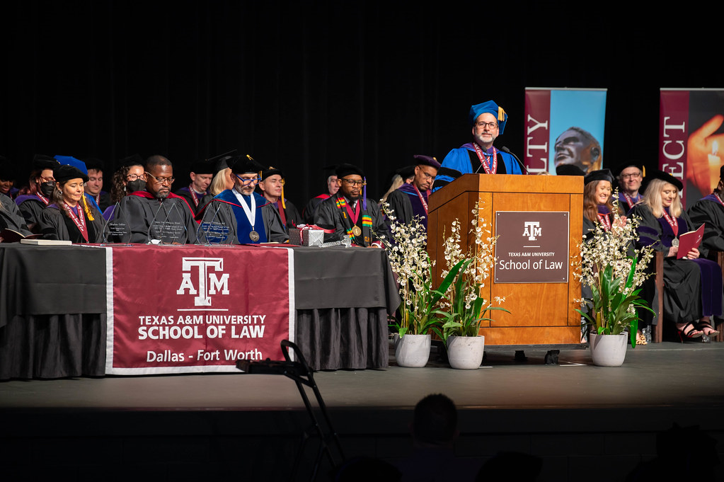 Dean Ahdieh and faculty on stage.