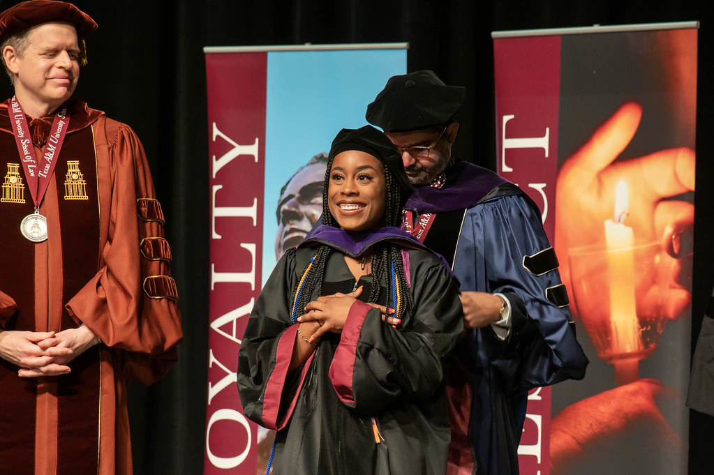 Student being hooded by a faculty member.